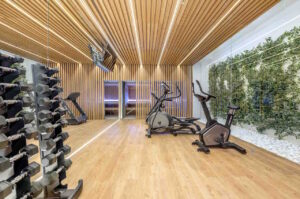 a room with exercise bikes and a wood floor