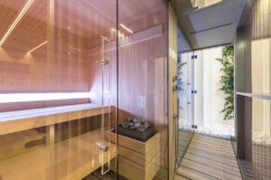 a sauna with glass doors and a glass door